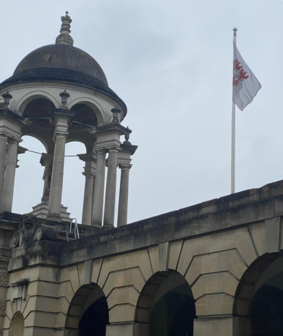 The Queen's College's flag flying above its entrance