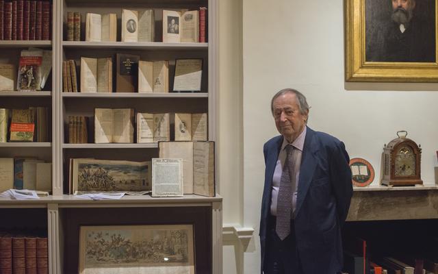 Sir Geoffrey Bindman, stood next to an exhibition of some of his books and prints
