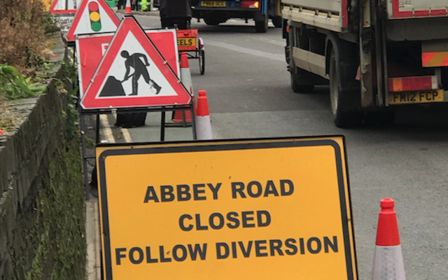 Road works and a sign saying 'Abbey Road closed, follow diversion'