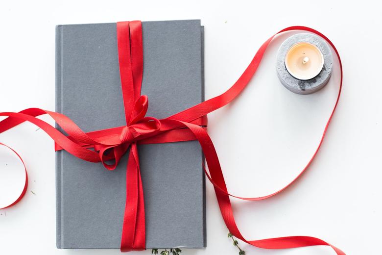Book wrapped in festive red ribbon
