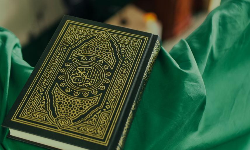 Quran on green fabric