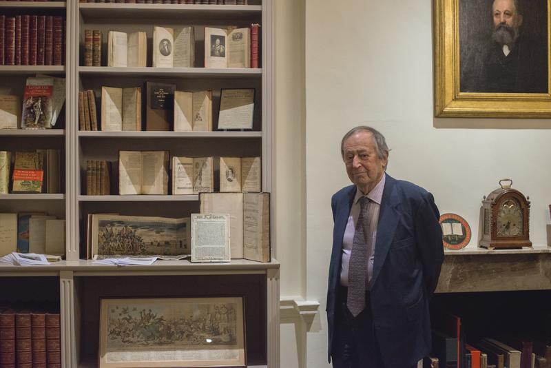 Sir Geoffrey Bindman, stood next to an exhibition of some of his books and prints