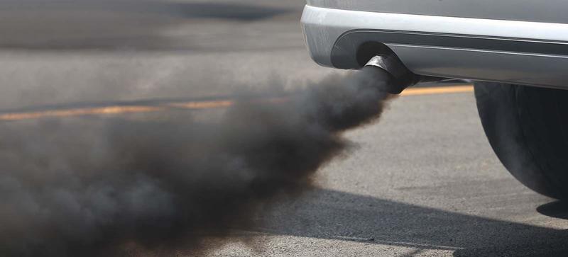 A car emitting a large amount of black smoke from its exhaust