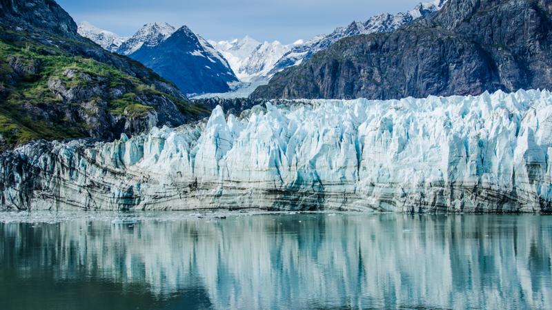 Close-up of Margerie Glacier in Glacier Bay National Park and Preserve in Southeast Alaska which is twenty-one miles long and one mile wide with layers of rock debris mixed with ice
